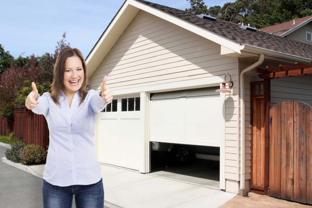 Happy woman with thumbs up after installing SnirtStopper Garage Door Seals on her house!
